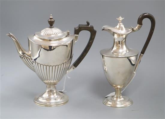 Two early 20th century silver vase shaped pedestal hot water pots including demi-fluted.